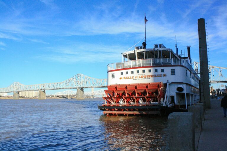 white and red ship on sea under blue sky during daytime