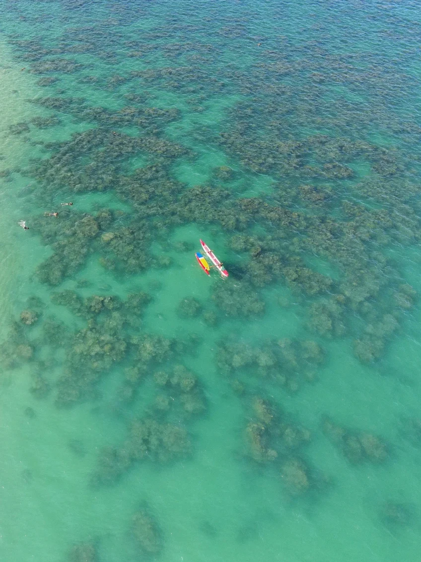 Drone view of Lanikai Beach in Hawaii showing turquoise water, soft sand, and gentle waves from above