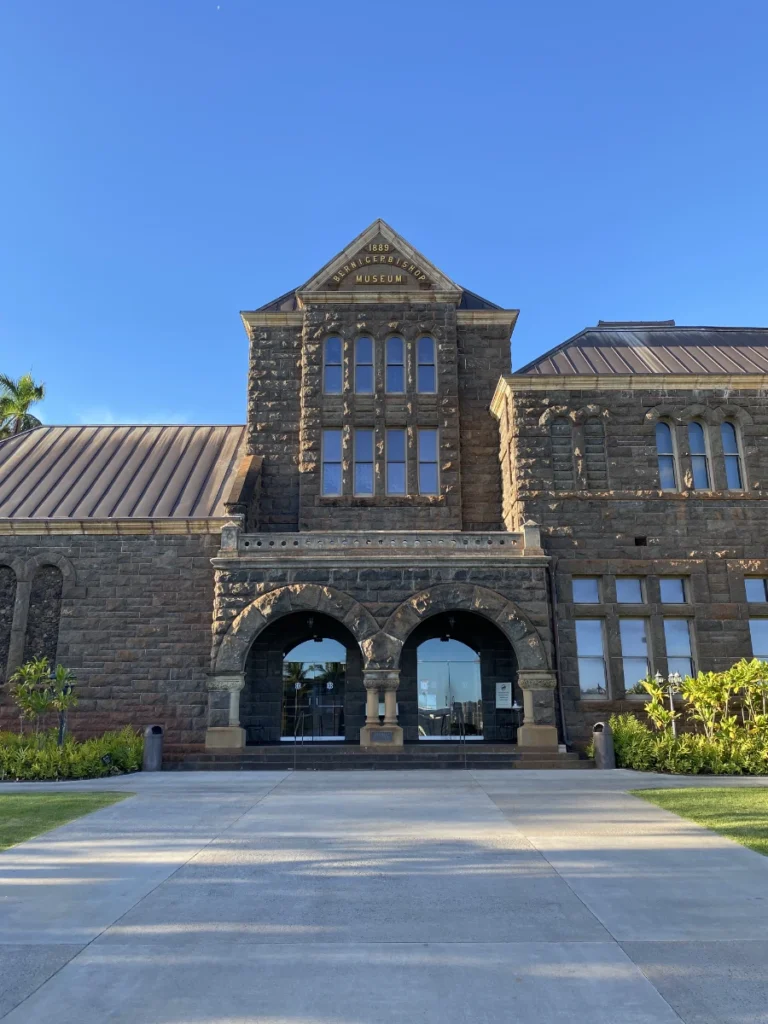 Exterior view of Bishop Museum in Honolulu, Hawaii with the main building and entrance