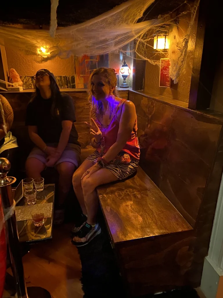 People dressed in Halloween costumes inside a bar during a night out