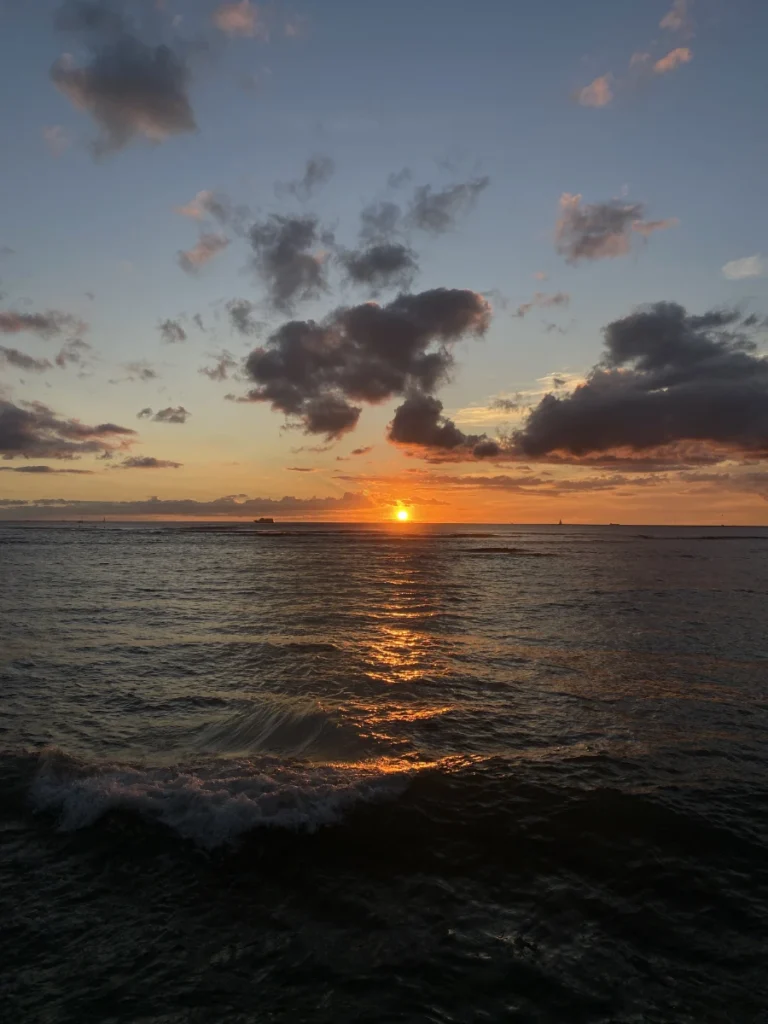 Final sunset in Hawaii with soft colors over the ocean as the day fades