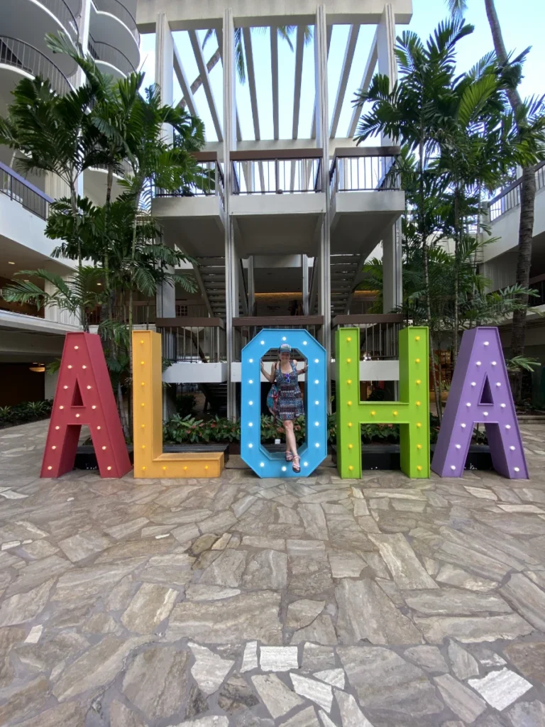 posing in front of the Aloha sign in Honolulu